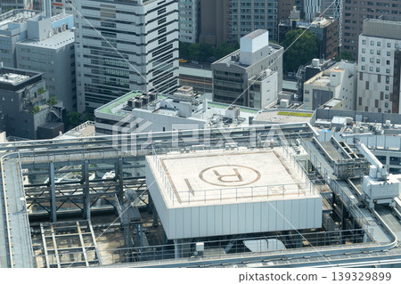 A helipad on the rooftop of a building in the city. A helipad on the rooftop of a building in the city. 139329899