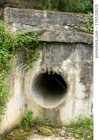 Concrete culvert drain pipe infrastructure in forest Concrete culvert drain pipe infrastructure in forest 139330029