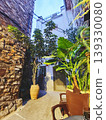 Charming sueras alley with old stone walls and lush plants 139330080