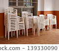 Stacked white plastic chairs preparing for public events 139330090