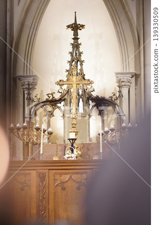 The church altar: A magnificent Gothic sanctuary lined with golden crosses and candlesticks. 139330509