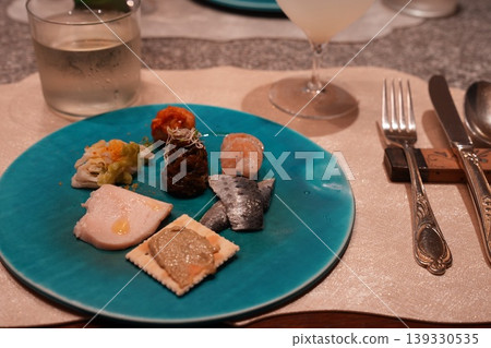 French appetizers: A platter of appetizers served on a turquoise plate. French appetizers: A platter of appetizers served on a turquoise plate. 139330535