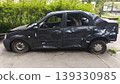 Side view of a damaged car with visible dents and impact marks, symbolizing the consequences of an accident, vehicle damage and the concept of road safety.  139330985