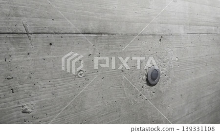 Raw concrete wall with subtle wood grain texture, emphasizing industrial character and refined structural detail. Raw concrete wall with subtle wood grain texture, emphasizing industrial character and refined structural detail. 139331108