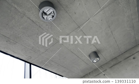 Raw concrete ceiling with two cylindrical ceiling lights, suitable for architectural or design projects and background 139331110