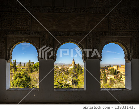 View of the Alhambra and Granada City Through Ornate Moorish Arches Framed by Gardens View of the Alhambra and Granada City Through Ornate Moorish Arches Framed by Gardens 139331433