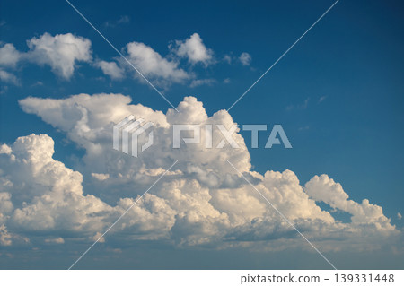 Blue sky with white summer rain clouds. Colorful summer landscape 139331448