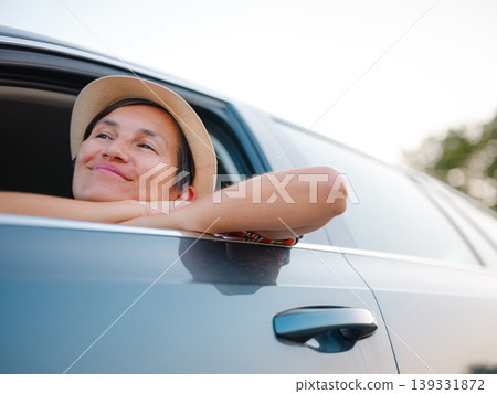 Traveler woman in red ethnic dress and hat drives car through scenic countryside of Croatia in summer. Surrounded by lush fields and forests, she enjoys peaceful and adventurous road trip Traveler woman in red ethnic dress and hat drives car through scenic countryside of Croatia in summer. Surrounded by lush fields and forests, she enjoys peaceful and adventurous road trip 139331872