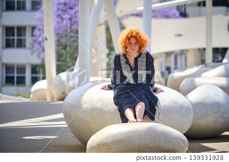 Fashion lifestyle portrait of red haired woman on urban bridge in sunlight Fashion lifestyle portrait of red haired woman on urban bridge in sunlight 139331928
