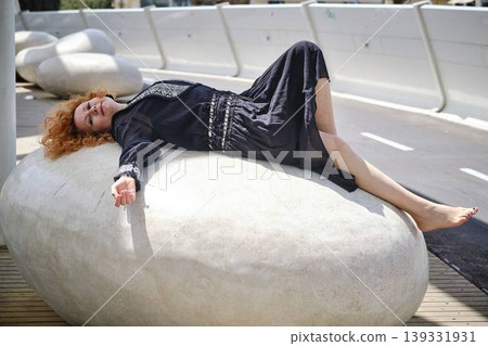 Fashion lifestyle portrait of red haired woman on urban bridge in sunlight Fashion lifestyle portrait of red haired woman on urban bridge in sunlight 139331931