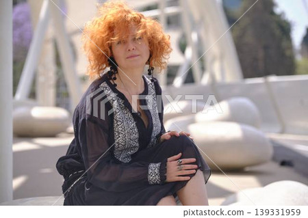Fashion lifestyle portrait of red haired woman on urban bridge in sunlight Fashion lifestyle portrait of red haired woman on urban bridge in sunlight 139331959