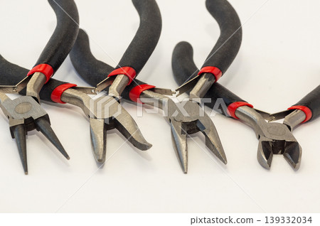 Set of different types of pliers and side cutters isolated on black background. Set of different types of pliers and side cutters isolated on black background. 139332034
