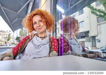 mature woman with paper umbrellas in cafe mature woman with paper umbrellas in cafe 139332094