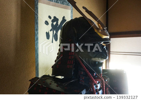 Traditional Japanese beauty: A dignified black lacquered suit of armor and helmet (with the five-seven paulownia family crest). 139332127
