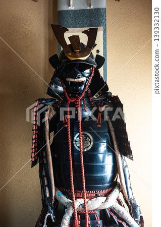 Traditional Japanese beauty: A dignified black lacquered suit of armor and helmet (with the five-seven paulownia family crest). Traditional Japanese beauty: A dignified black lacquered suit of armor and helmet (with the five-seven paulownia family crest). 139332130