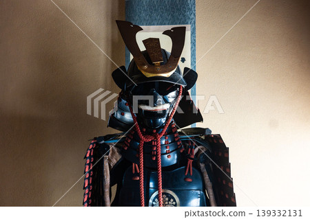 Traditional Japanese beauty: A dignified black lacquered suit of armor and helmet (with the five-seven paulownia family crest). Traditional Japanese beauty: A dignified black lacquered suit of armor and helmet (with the five-seven paulownia family crest). 139332131