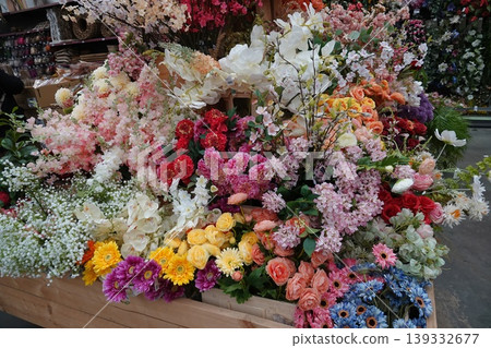 Abundant Display of Colorful Artificial Flowers in Rustic Wooden Crate for Decorative Arrangements Abundant Display of Colorful Artificial Flowers in Rustic Wooden Crate for Decorative Arrangements 139332677