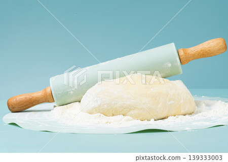 Flour, rolling pin, and pie dough. Flour, rolling pin, and pie dough. 139333003