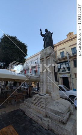 A square with a monument in touristy area of Gozo island 139333137