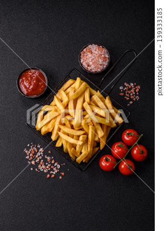 Crispy, fresh, golden French fries with salt, unhealthy takeaway food. French fries 139333185