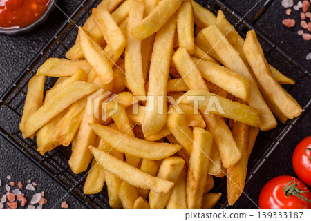 Crispy, fresh, golden French fries with salt, unhealthy takeaway food. French fries 139333187