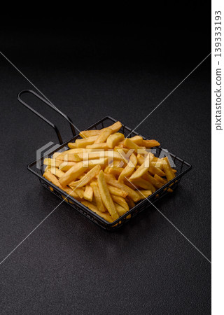 Crispy, fresh, golden French fries with salt, unhealthy takeaway food. French fries 139333193