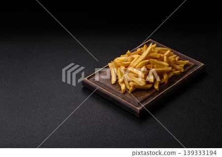 Crispy, fresh, golden French fries with salt, unhealthy takeaway food. French fries 139333194