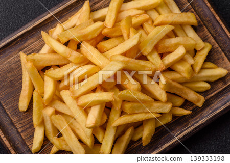 Crispy, fresh, golden French fries with salt, unhealthy takeaway food. French fries 139333198