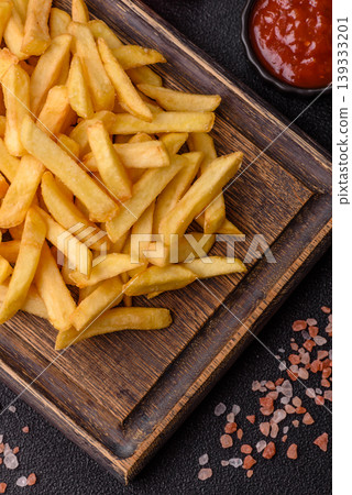 Crispy, fresh, golden French fries with salt, unhealthy takeaway food. French fries 139333201