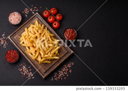 Crispy, fresh, golden French fries with salt, unhealthy takeaway food. French fries 139333203