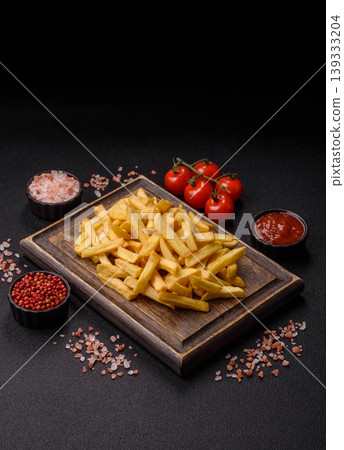 Crispy, fresh, golden French fries with salt, unhealthy takeaway food. French fries 139333204