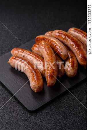 Grilled or barbecued chicken sausages for the dinner table. Grilled sausages 139333231