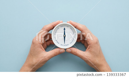 emale Hands Holding Compass with BREATHE Text Mindfulness and Calm Concept emale Hands Holding Compass with BREATHE Text Mindfulness and Calm Concept 139333367
