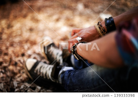 Hands, relax and quiet with a person on the ground, sitting alone in autumn for peace or calm in nature. Forest, woods or wilderness with an adult closeup from above in the outdoors during fall Hands, relax and quiet with a person on the ground, sitting alone in autumn for peace or calm in nature. Forest, woods or wilderness with an adult closeup from above in the outdoors during fall 139333398