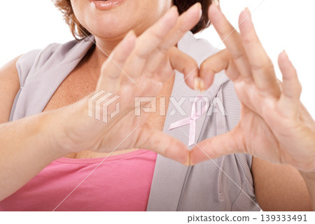 Woman, ribbon and heart hands for breast cancer awareness, love or care against a white studio background. Closeup of female person with like emoji, symbol or gesture in support or community campaign Woman, ribbon and heart hands for breast cancer awareness, love or care against a white studio background. Closeup of female person with like emoji, symbol or gesture in support or community campaign 139333491