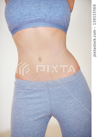 Diet, stomach and figure of woman for fitness, workout and exercise for healthy body. Nutrition, gut health and closeup of abdomen, tummy and torso of person for wellness, digestion and lose weight 139333569