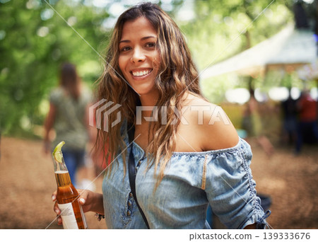 Portrait of woman at music festival with smile, beer and relax in nature for concert event. Drink, celebration and girl at outdoor party for freedom, adventure and happy people in park, forest or sun Portrait of woman at music festival with smile, beer and relax in nature for concert event. Drink, celebration and girl at outdoor party for freedom, adventure and happy people in park, forest or sun 139333676