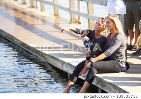 People, drink and holiday at lake with beer, water or deck in summer with women pointing to view. Friends, party and relax at dam with alcohol, chat and fun at social, event or sitting on pier People, drink and holiday at lake with beer, water or deck in summer with women pointing to view. Friends, party and relax at dam with alcohol, chat and fun at social, event or sitting on pier 139333718