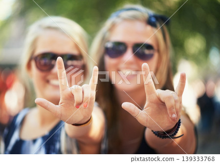 Rock, hands or portrait of friends in music festival on holiday vacation together to relax with smile. Party, reunion celebration or excited gen z women with devil horns for a fun memory or event Rock, hands or portrait of friends in music festival on holiday vacation together to relax with smile. Party, reunion celebration or excited gen z women with devil horns for a fun memory or event 139333768