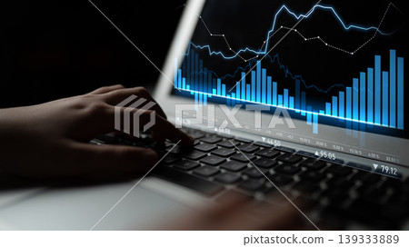 Close-up of a person typing on a laptop while analyzing financial charts and graphs, showcasing data analysis and technology in a dark environment Scalp Close-up of a person typing on a laptop while analyzing financial charts and graphs, showcasing data analysis and technology in a dark environment Scalp 139333889