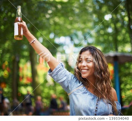 Happy woman at music festival with dance, beer and relax in woods for concert event. Alcohol, celebration and excited girl at outdoor party in freedom, adventure and person in park, forest and smile. Happy woman at music festival with dance, beer and relax in woods for concert event. Alcohol, celebration and excited girl at outdoor party in freedom, adventure and person in park, forest and smile. 139334040