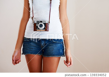 Camera, woman and closeup of a photographer in studio for travel, photography or creativity. Trendy casual fashion of a female model person, student or tourist on a white background in shorts Camera, woman and closeup of a photographer in studio for travel, photography or creativity. Trendy casual fashion of a female model person, student or tourist on a white background in shorts 139334052