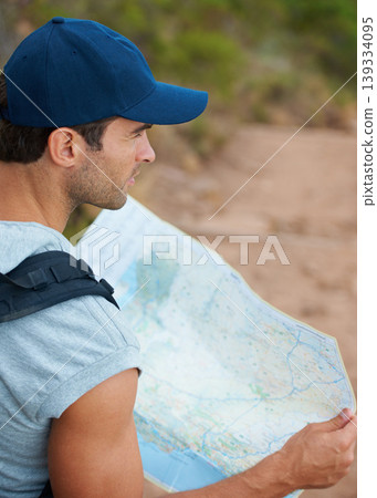 Man, hiking and map for direction, guide and nature or trail, fitness and exercise on holiday. Male person, lost and documents for information, travel and journey or adventure to forest for cardio 139334095