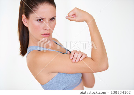 Woman, portrait or serious in studio with flex for fitness, wellness or workout strength and sportswear. Person, athlete or pride for biceps, exercise or training on white background or mock up space Woman, portrait or serious in studio with flex for fitness, wellness or workout strength and sportswear. Person, athlete or pride for biceps, exercise or training on white background or mock up space 139334102