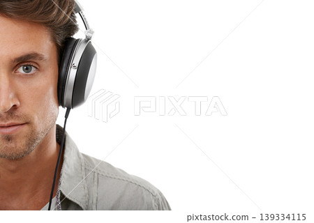 Headphones, man and face portrait with space in studio for music subscription, streaming multimedia and radio on white background. Serious model listening to podcast, hearing sound or audio on mockup Headphones, man and face portrait with space in studio for music subscription, streaming multimedia and radio on white background. Serious model listening to podcast, hearing sound or audio on mockup 139334115