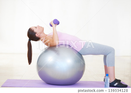 Woman, ball and balance or weight exercise on mat for .cardio or progress training, workout for fitness. Female person, sports for gym club or active healthy, strong wellbeing challenge for practice Woman, ball and balance or weight exercise on mat for .cardio or progress training, workout for fitness. Female person, sports for gym club or active healthy, strong wellbeing challenge for practice 139334128