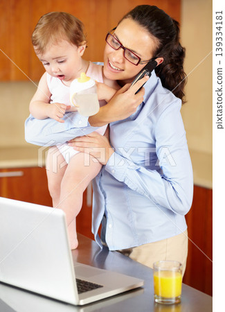 Mother, baby and phone call on laptop for work from home, business planning and multitasking in kitchen. Single mom, woman or freelancer talking on mobile and computer for communication and childcare 139334181