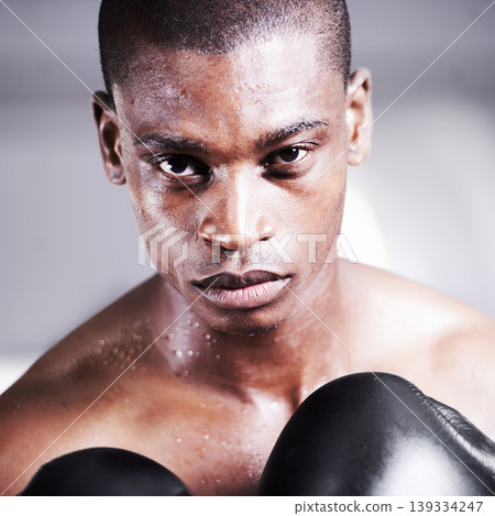 Boxing, gloves and portrait of black man with power, fitness and workout challenge at sports club. Strong body, face of athlete or warrior boxer in gym with sweat and confidence in competition fight. 139334247