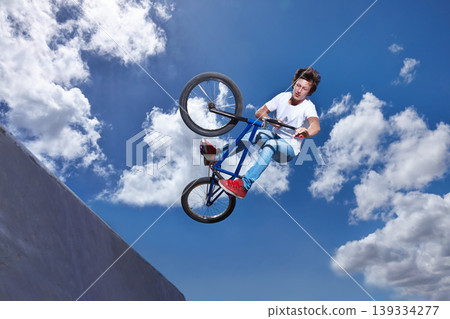 Ramp, jump and man with bike in sky at park, event or competition for sport with risk and energy. Mockup, space and person in air with trick or stunt on bicycle for fun in summer with adventure Ramp, jump and man with bike in sky at park, event or competition for sport with risk and energy. Mockup, space and person in air with trick or stunt on bicycle for fun in summer with adventure 139334277
