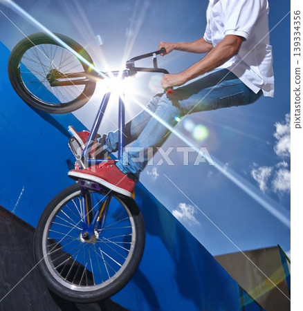 Ramp, trick and man with bicycle in air at park, event or competition for sport with risk and balance. Mockup, space or person in sky with fearless stunt on bike for fun adventure or action in summer Ramp, trick and man with bicycle in air at park, event or competition for sport with risk and balance. Mockup, space or person in sky with fearless stunt on bike for fun adventure or action in summer 139334356